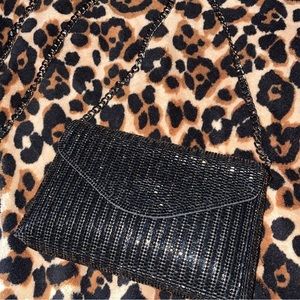 Sparkly black shoulder bag with detachable chain.
